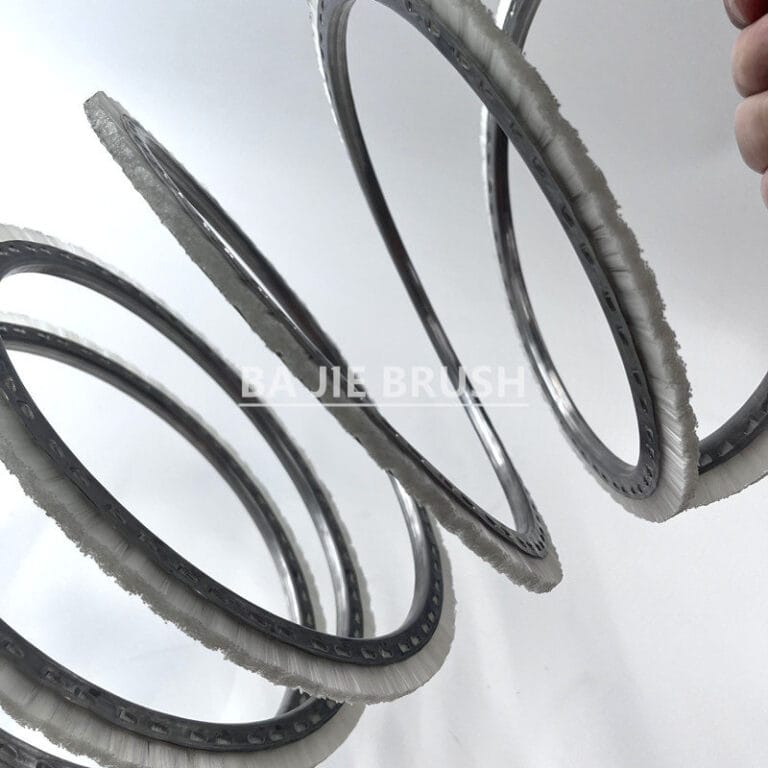 Auger flight brush with reinforced stainless steel spiral backing