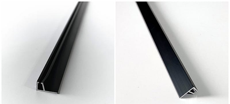 Two views of empty black anodised aluminum holder profiles used with metal channel door seal brushes