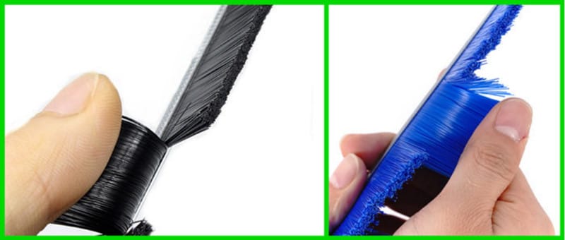 Manual bristle retention check on black and blue industrial brush seals