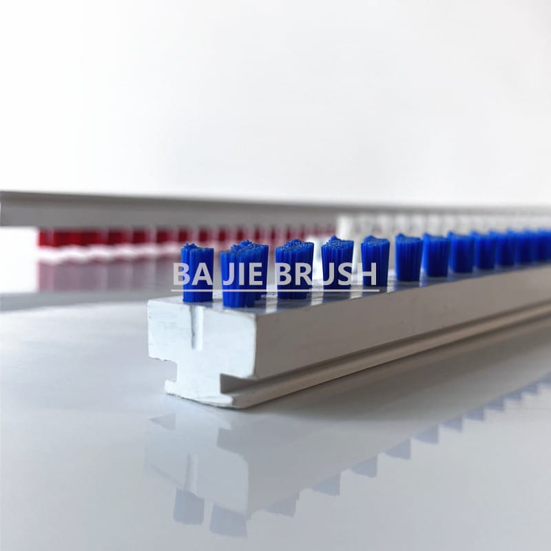C Track lath brush with blue bristle tufts in a replaceable plastic base