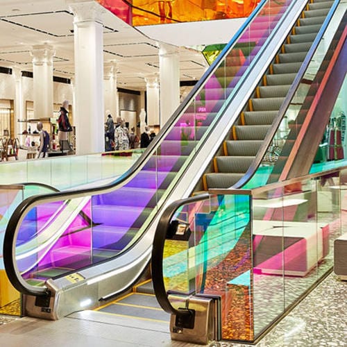 Escalator in a commercial building using side safety brush strips
