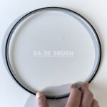 External ring brush with outward-facing black bristles