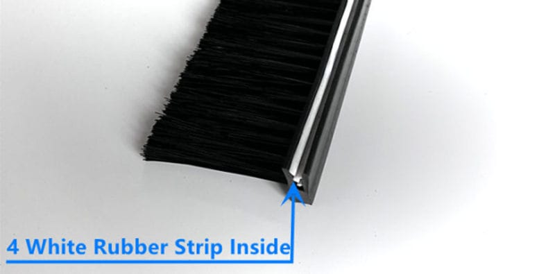 Four soft rubber grip strips inside the grooved profile of a side-tufted strip brush