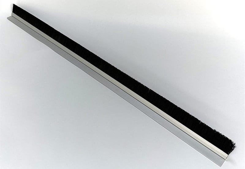 Full-length black nylon brush strip in an anodized angled aluminum profile for vertical rack installation
