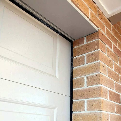 Strip brush seal installed along the edge of a garage door