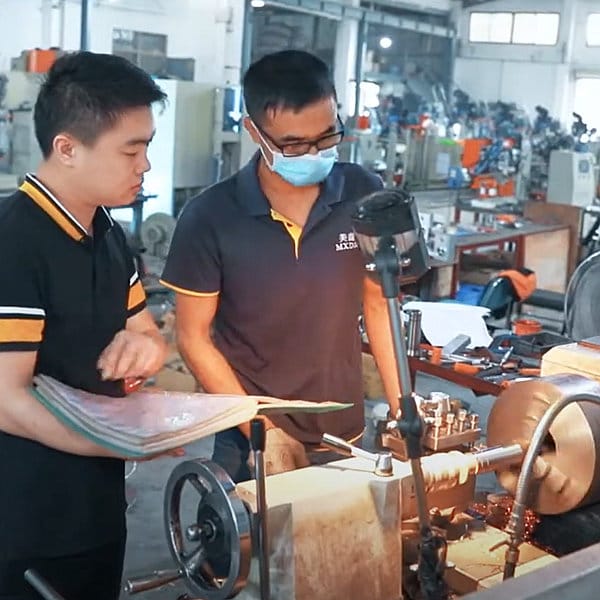 BaJie Brush production staff operating brush manufacturing equipment