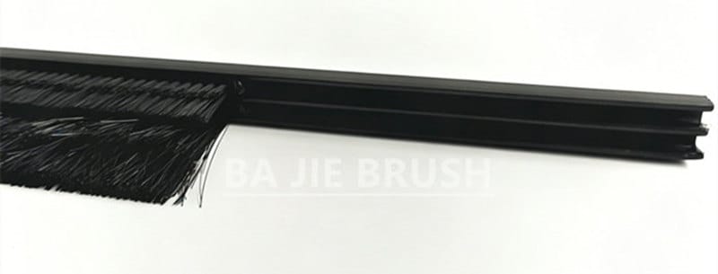 Server rack brush strip with tufted nylon brushes in a snap-on PVC profile