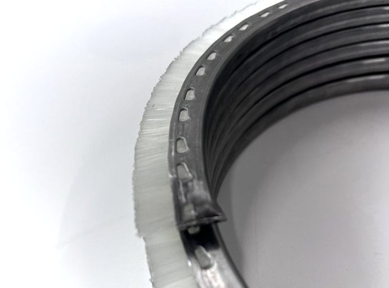 Pressed locking holes along the stainless steel backing retain the nylon bristles