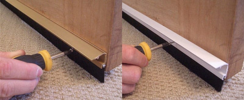 Gold and white PVC door brush profiles being screw-fixed before the cover clips conceal the mounting channels