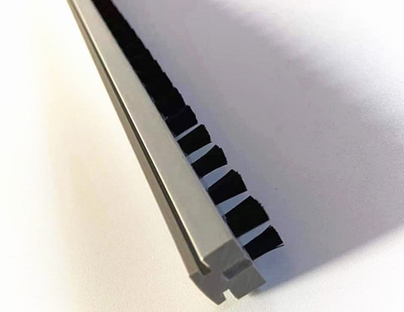 Plastic lath brush base retained inside a metal C-shaped mounting track