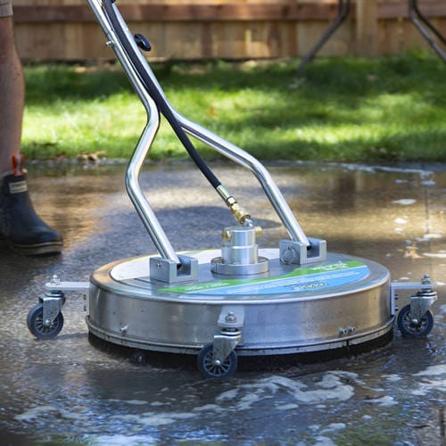 Rotary surface cleaning machine using a perimeter brush on wet pavement