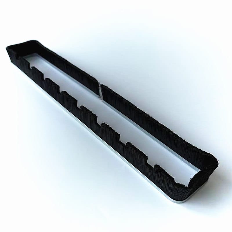 Formed floor nozzle brush strip with black filaments