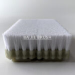 Velour brush segment with toothed plastic base