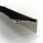 Side view of a barn door brush sweep showing the aluminum holder and brush strip