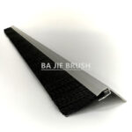 Angled view of a sliding door brush seal showing the mounting flange and bristle arrangement
